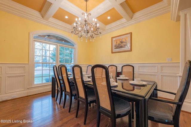 dining room with hardwood / wood-style floors, coffered ceiling, a notable chandelier, ornamental molding, and beamed ceiling