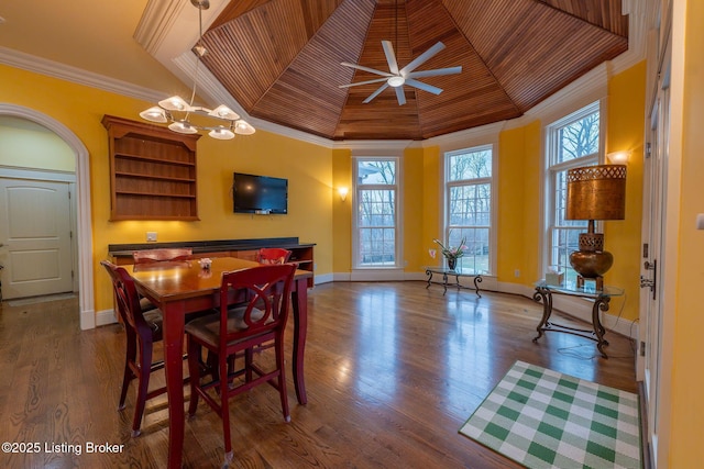 dining space featuring crown molding, a healthy amount of sunlight, and a tray ceiling