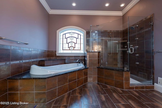 bathroom with crown molding and shower with separate bathtub