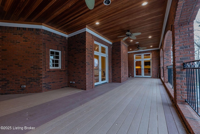 wooden terrace featuring french doors and ceiling fan