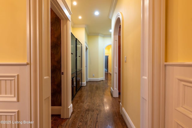 hallway featuring dark hardwood / wood-style flooring and ornamental molding