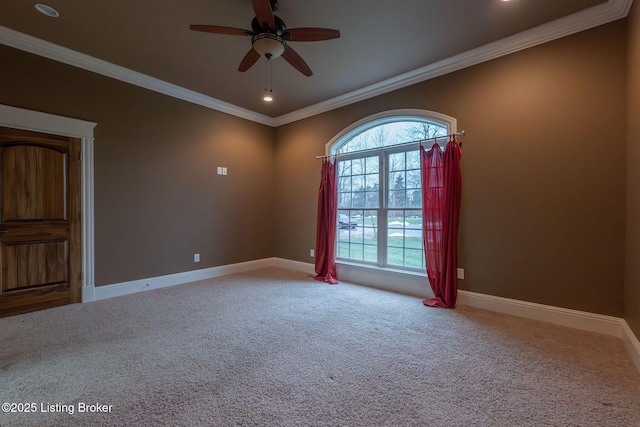 spare room with crown molding, ceiling fan, and carpet flooring