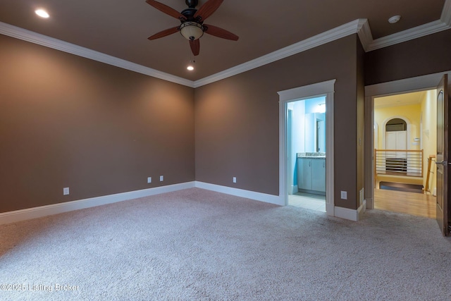 carpeted spare room with crown molding and ceiling fan