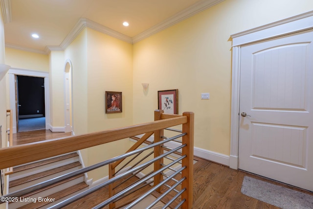 corridor featuring dark wood-type flooring and ornamental molding