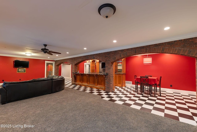 living room featuring crown molding and ceiling fan