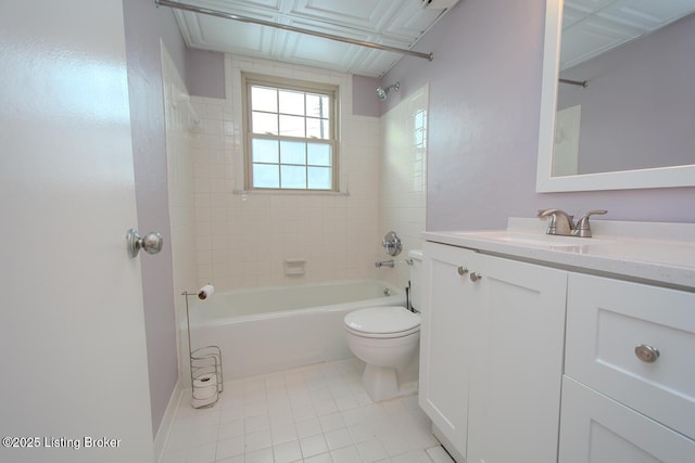 full bathroom with vanity, tiled shower / bath combo, tile patterned floors, and toilet