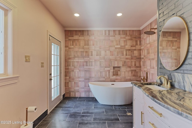 bathroom with a bath, crown molding, a wealth of natural light, and vanity