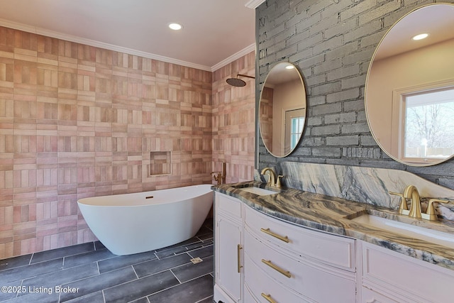 bathroom with vanity, ornamental molding, and a bathing tub