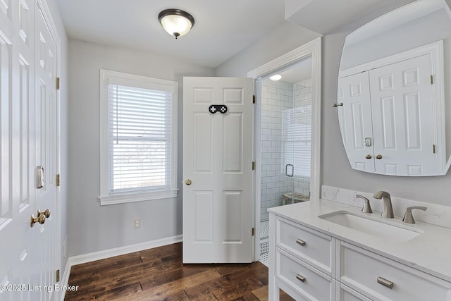 bathroom featuring a healthy amount of sunlight, a shower with door, vanity, and hardwood / wood-style flooring