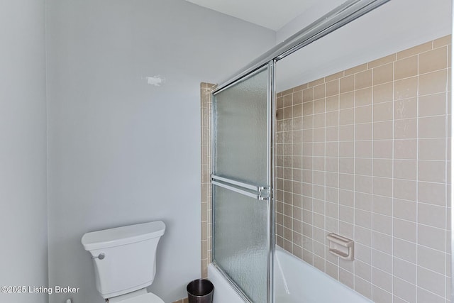 bathroom with toilet and enclosed tub / shower combo