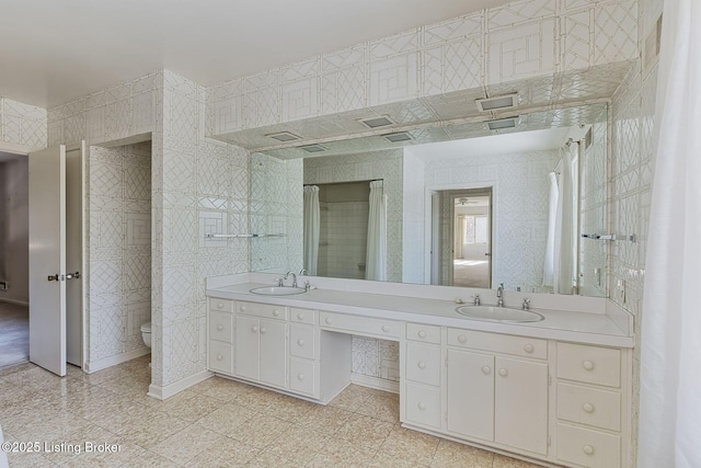 bathroom featuring toilet and vanity