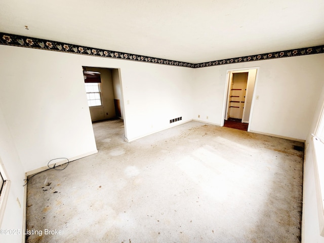 empty room featuring visible vents and baseboards