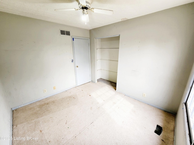 unfurnished bedroom with ceiling fan, visible vents, and a closet