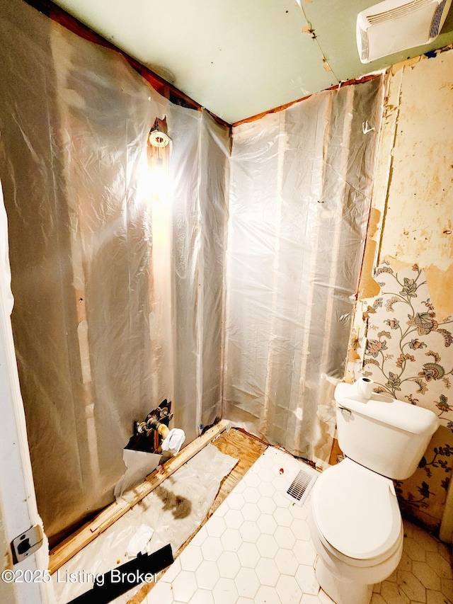 bathroom featuring toilet and visible vents