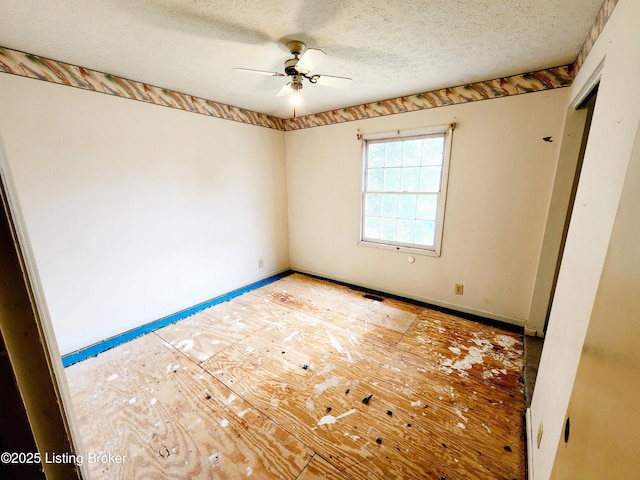 unfurnished bedroom featuring ceiling fan, a textured ceiling, and baseboards