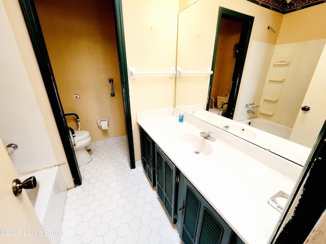 full bath with tile patterned flooring, toilet, vanity, baseboards, and washtub / shower combination