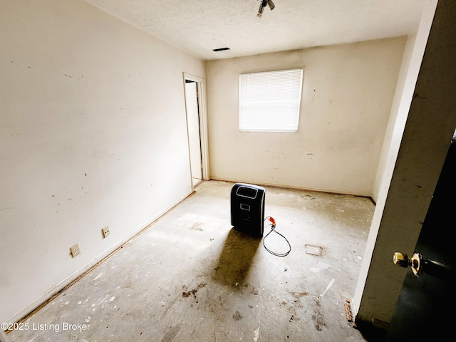 spare room with visible vents and a textured ceiling