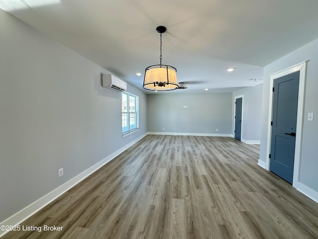 interior space featuring light wood-type flooring and a wall mounted air conditioner