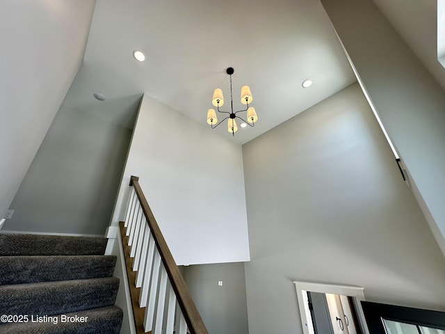 stairway with a notable chandelier