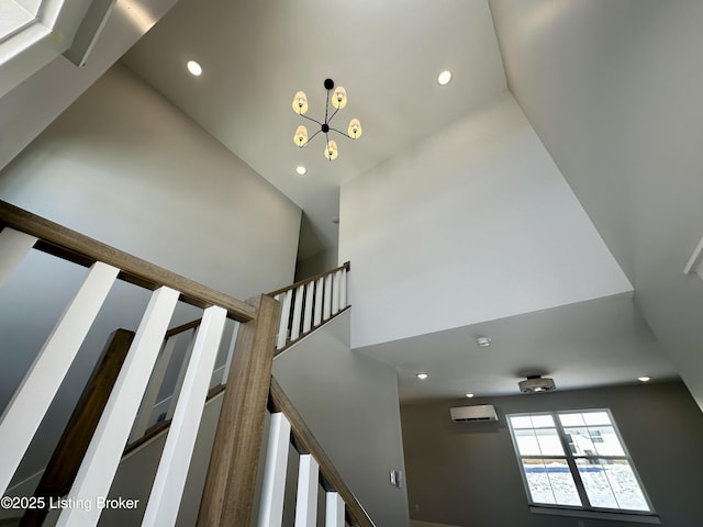 staircase with a notable chandelier