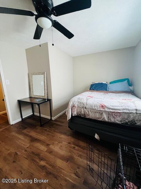 bedroom with ceiling fan and dark wood-type flooring