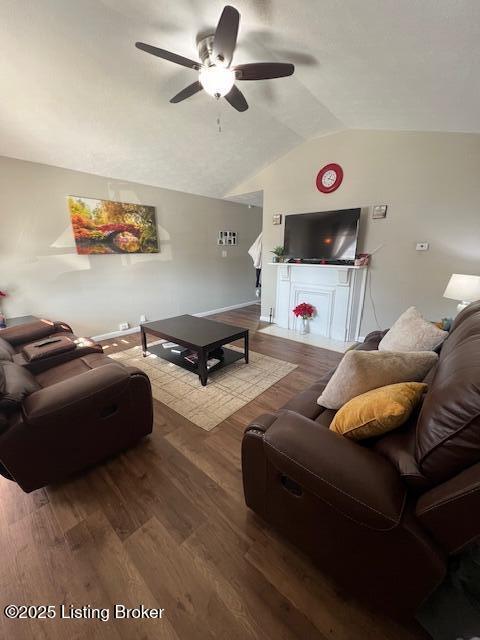 living room featuring hardwood / wood-style flooring, lofted ceiling, and ceiling fan