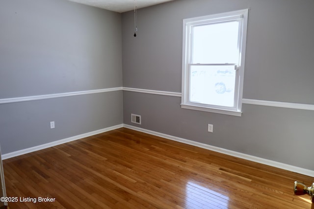 spare room featuring hardwood / wood-style floors