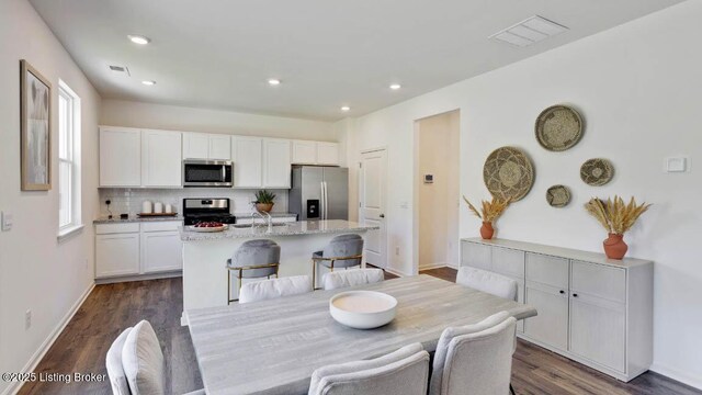 dining area with sink and dark wood-type flooring