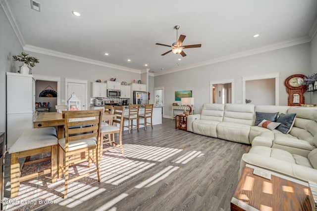 living room featuring ceiling fan, crown molding, and hardwood / wood-style floors