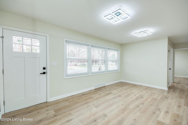 foyer entrance featuring plenty of natural light and light hardwood / wood-style flooring