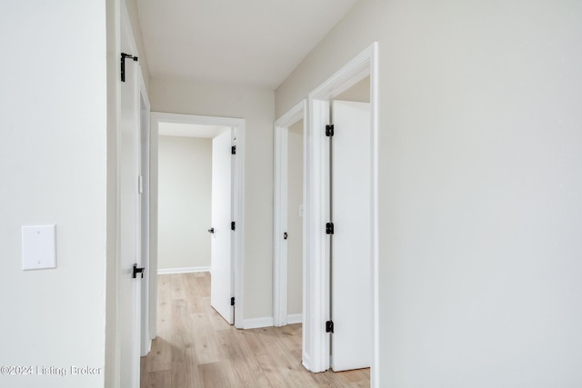 corridor with light wood-type flooring