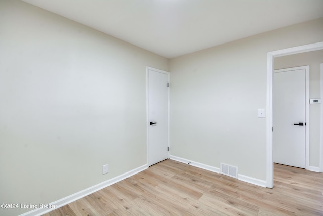 empty room with light hardwood / wood-style flooring