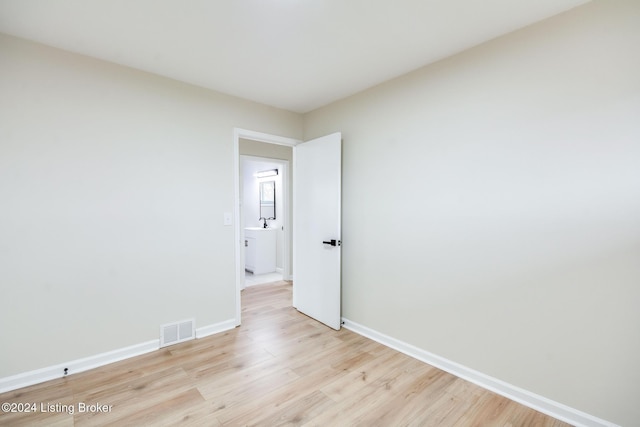 spare room featuring light hardwood / wood-style flooring and sink