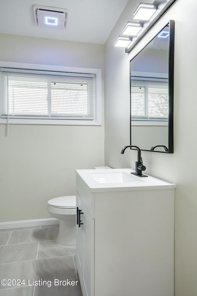 bathroom with tile patterned floors, vanity, and toilet