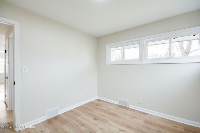 spare room featuring light hardwood / wood-style floors