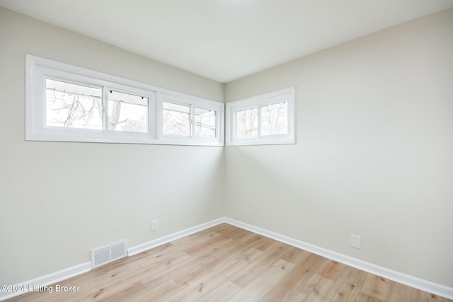 unfurnished room with light hardwood / wood-style floors