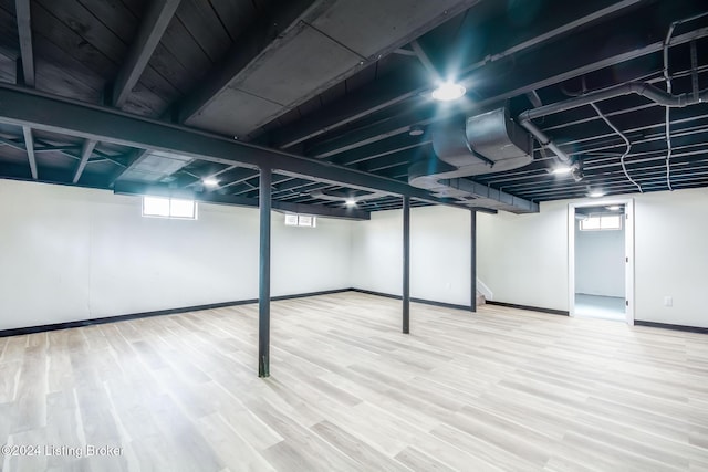 basement with hardwood / wood-style flooring