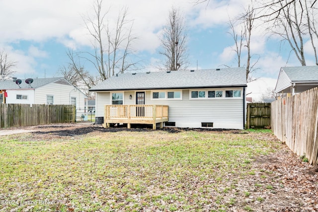 rear view of house featuring a yard, cooling unit, and a wooden deck