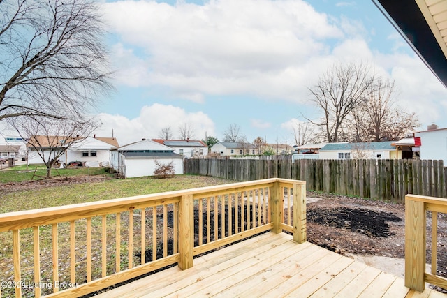 wooden deck featuring an outbuilding and a yard