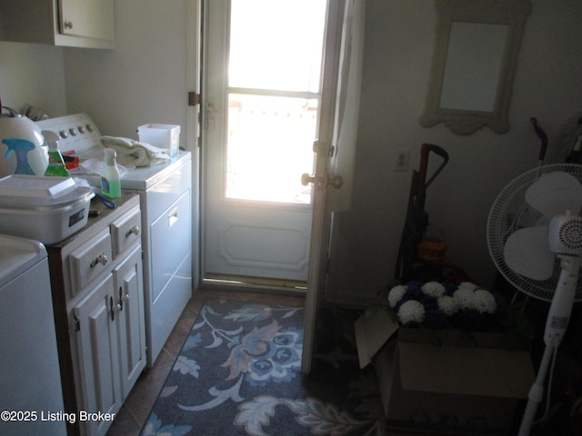 washroom with cabinets, tile patterned floors, and washer and dryer