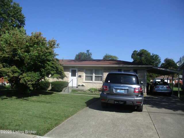 view of front of house with a carport and a front lawn