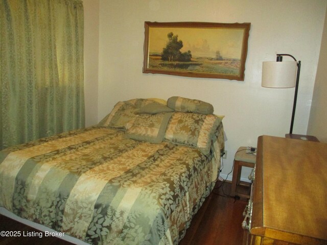 bedroom featuring dark wood-type flooring