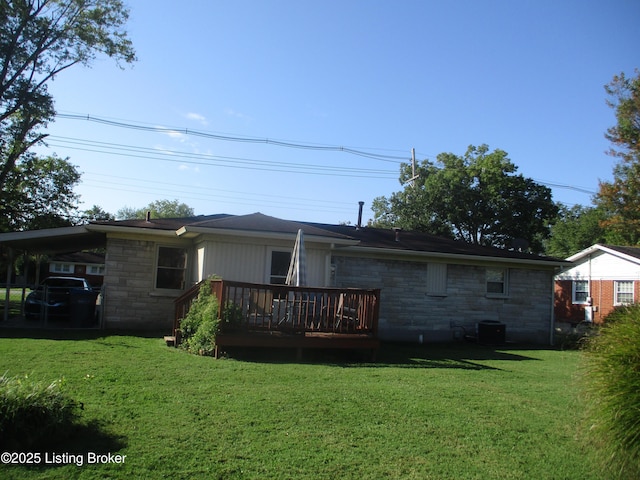 back of property featuring a carport, cooling unit, a deck, and a lawn