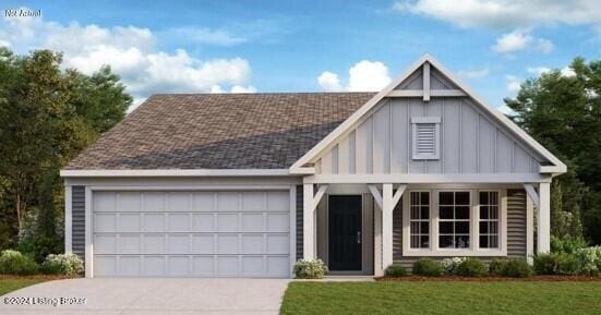 view of front of house with a garage and a front lawn