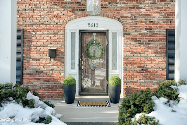 view of snow covered property entrance