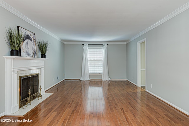 unfurnished living room with hardwood / wood-style floors and crown molding