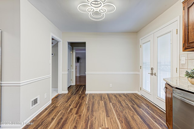 unfurnished dining area with dark hardwood / wood-style floors and french doors