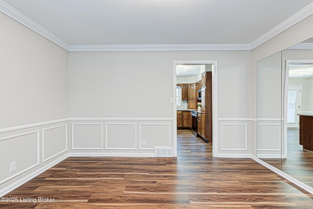 unfurnished room with dark wood-type flooring and ornamental molding