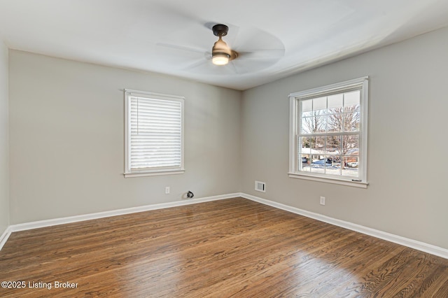 spare room featuring ceiling fan and dark hardwood / wood-style floors