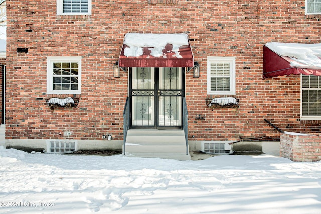 view of snow covered property entrance